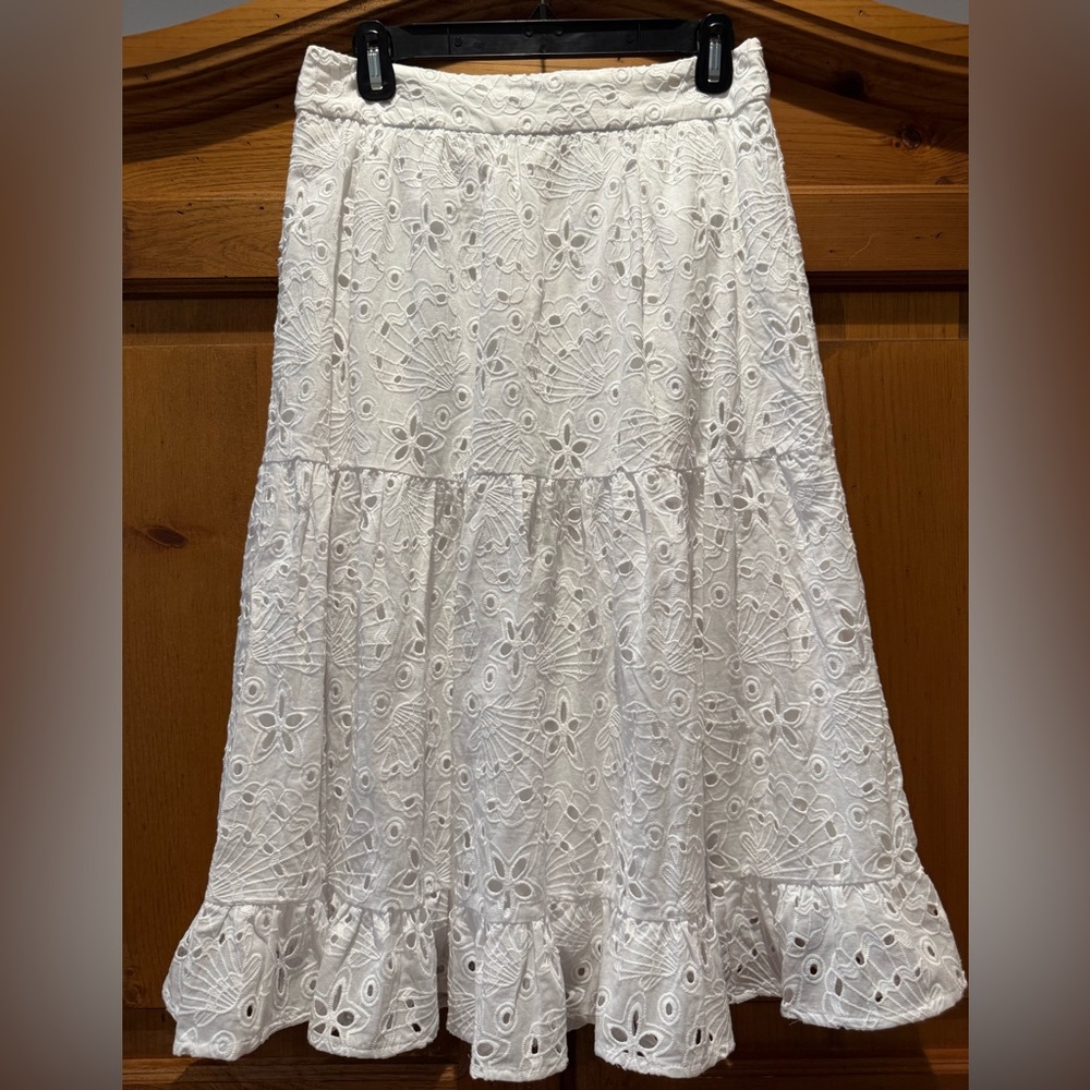 White eyelet lined skirt.  New with tags.  Great looking on.  Very stylish.